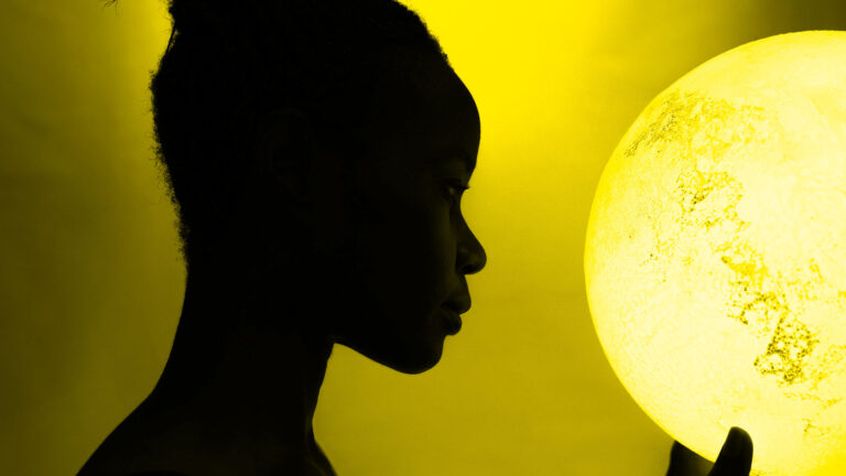 Black woman holding a moon model